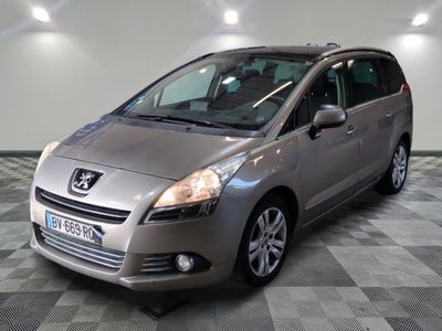 a picture of a silver minivan parked in a garage