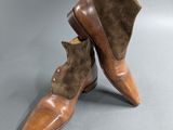 a pair of brown leather boots with brown sued soles
