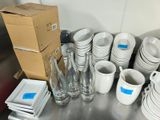 a lot of white dishes and cups on the table