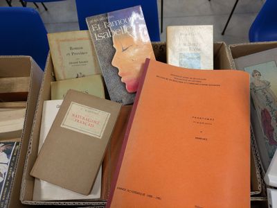 many books that are in a box on the table