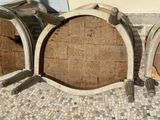 two wine barrels sitting next to each other on a tiled floor