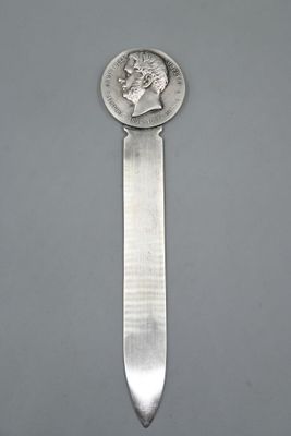 an image of a knife with a coin on it