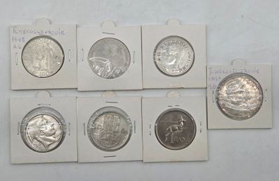 six different types of silver coins are on display on a white surface