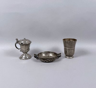 two silver cups and a silver cup on a white surface