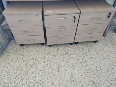 two desks with drawers and a computer on top of them