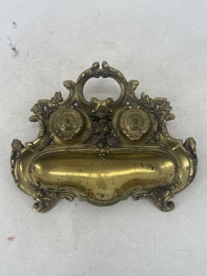 an antique brass plate with a flower design on it