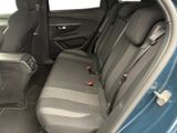 the back seats of a blue car are empty and the passenger seat is empty