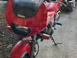 many motorcycles parked next to each other on the side of the road