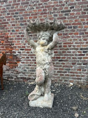 a statue of a woman holding a bowl on her head