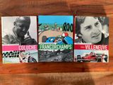 trois livres posés sur une table en bois, avec la photo d'un homme dans une voiture de course