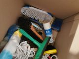 a box full of cleaning supplies and a brush in it