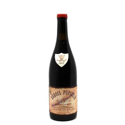 a bottle of wine sitting on top of a white table