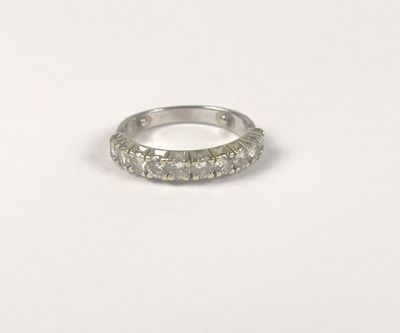 a close up of a diamond ring on a white surface