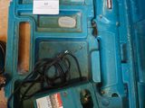 a blue box with a drill and a cord in it