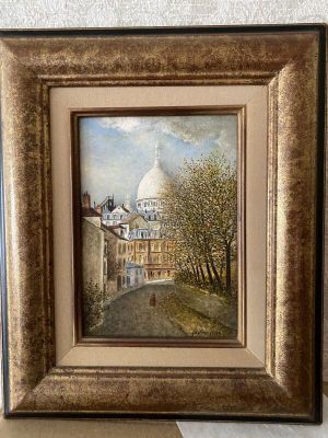 framed oil painting of a street scene with a church in the background