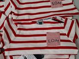 several red and white striped shirts are stacked on top of each other