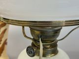 a lamp that is sitting on a table next to a vase