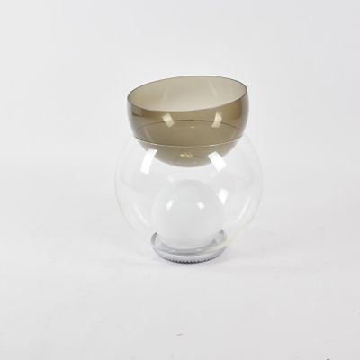 a glass vase with a gold rim sitting on a white surface