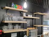 a kitchen with a lot of bottles and glasses on the shelves