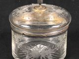 a glass jar with a lid on a black surface