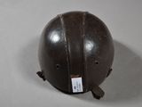 a brown helmet on a table with a tag on it