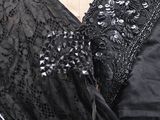 a close up of a black dress on a mannequin mannequin