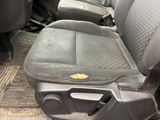 an image of a dirty car seat with a yellow sticker on it