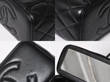 a black purse with a mirror and a mirror in it