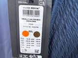a label on the back of a blue jacket