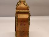 a small wooden box with a painting on it