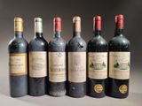 six bottles of wine are lined up in a row on a table