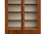 a large wooden bookcase with glass doors and shelves