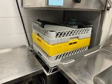 a yellow basket sitting on top of a metal shelf