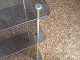 a glass table with a glass shelf on top of it