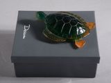 a small turtle that is sitting on top of a box