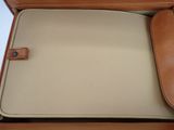 beige and tan leather case for a laptop with a leather handle