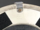 a close up of a toilet seat with a black and white checkered seat cover