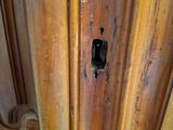 a close up of a wooden door with a hole in it