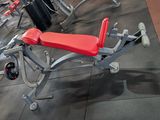 a red bench in the middle of a gym