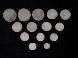 several silver coins are arranged in a heart shape on a black background