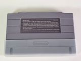 an old nintendo game console sitting on top of a white table