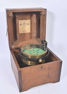 a small wooden box with a compass inside of it