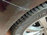 a close up of a car tire on a wooden surface