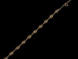 a close up of a gold bracelet on a black background
