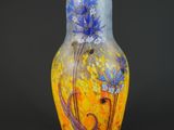 vase jaune et bleu orné de fleurs sur fond noir