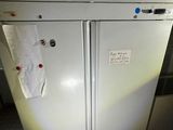 a white refrigerator that has a lot of magnets on it