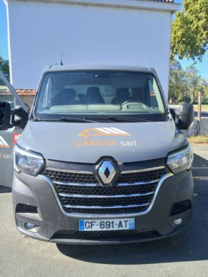 a grey van that is parked in a parking lot