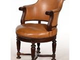 a brown leather chair sitting on top of a wooden table