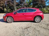 a picture of a red car parked in a parking lot
