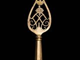 a gold trophy with a crown on top of it on a black background